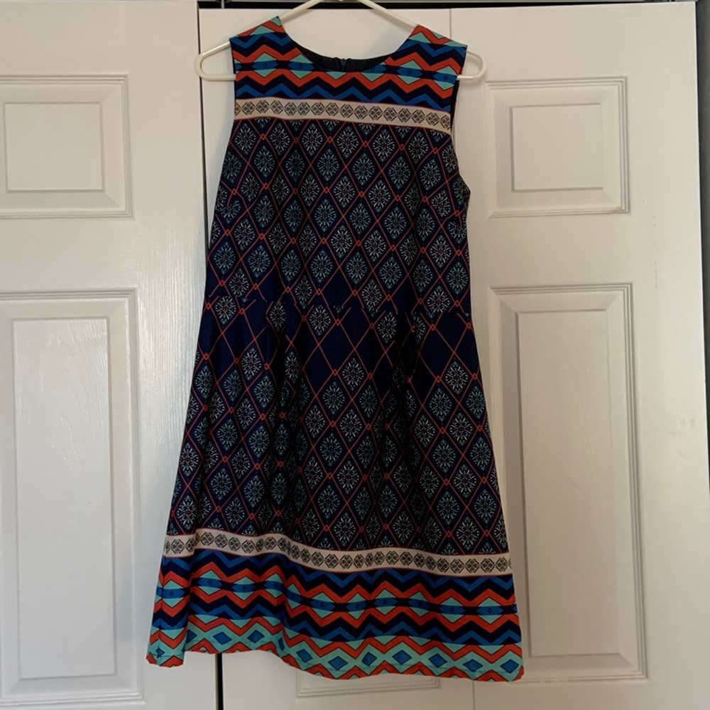 Size medium. Boutique fit and flare dress. Navy with coral and teal.